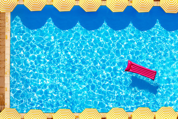 Pool with matrass and umbrellas view from above © Sergey Novikov