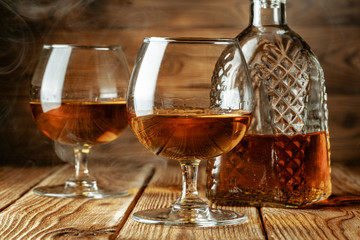 Cognac or whiskey in glasses on rustic backgrpund