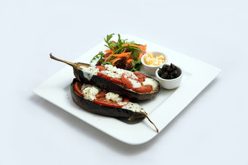 A low contrast warm Hero shot of a main course platter with grilled aubergine with buffalo cheese on a minimal white background with a 45 degree angle from diagonal perspective.