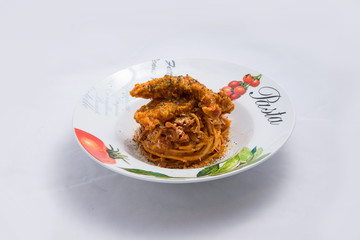 A low contrast Hero shot of chicken curry with pasta noodles in a plate with minimal white background with 60 degree angle from front perspective