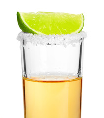 Shot of tequila with a slice of lime no white background