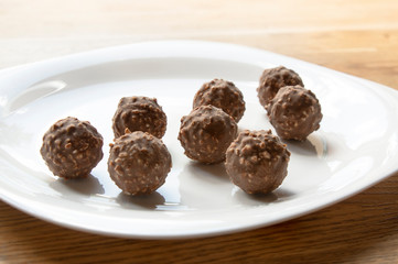 round chocolate with nuts on a white plate