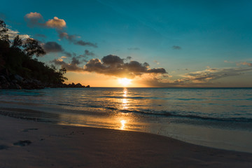 Fototapeta na wymiar Sunset at a sandy beach in Seychelles