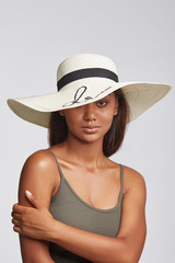 "young girl, dark-skinned girl, smiling girl, brunette girl,  hat with a wide brim, milky-white hat, beach hat, straw sun hat, off-face sun hat, wide brim hat, sequins embroidery, black ribbon, khaki-