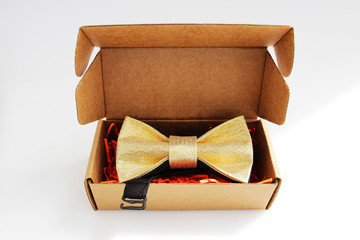 bow tie in a cardboard gift box. color gold