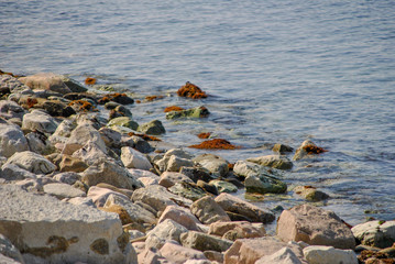 pebble beach with rocks in the water