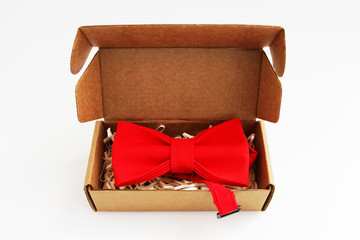bow tie in a cardboard gift box. Color red