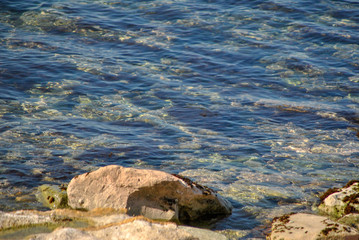 pebble beach with rocks in the water
