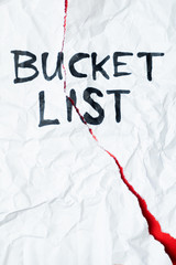 Phrase "bucket list" handwritten on crumpled torn paper, top view. Sign, concept of failed plans or hopes, abstract illustrative image