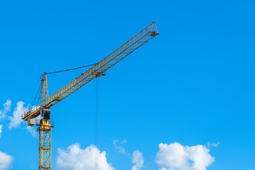 Big yellow crane with blue sky