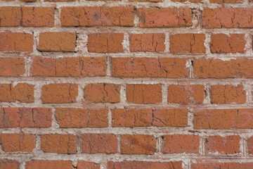 old red brick wall with cracks and defects