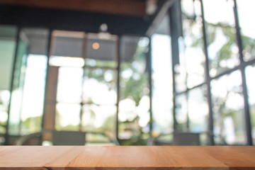 Wooden table with Blurred of coffee's shop for abstract background