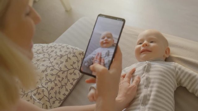 A shot of a phone, taking pictures of a baby