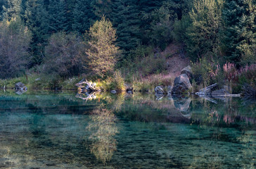 The stunning Kimball Lake with clear blue water and reflection of shoreline located in Klamath...