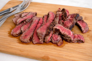 Sliced Rare Steak on a Cutting Board