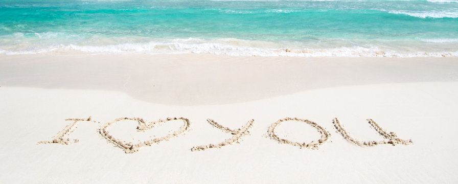 Words I Love You on beach. vacation concept background