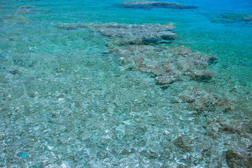 top view of Red sea transparent aquamarine water with coral riffs on bottom  