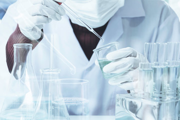 Researcher with glass laboratory chemical test tubes with liquid for analytical , medical, pharmaceutical and scientific research concept.