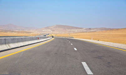 Fototapeta premium endless scenic road across somewhere in Azerbaijan . Empty asphalt road across vast hilly landscape of Azerbaijan .
