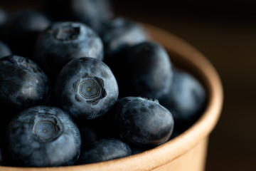 Macro shot of organic blueberries in a paper cup