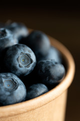 Macro shot of organic blueberries in a paper cup