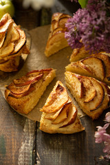 homemade apple cinnamon scones with lilac flowers and apple blooming branches. English breakfast or brunch at the village