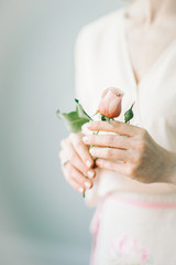 woman with beautiful fingers holding pink rose