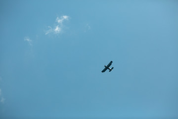 silhouette of flying airplane in the blue sky