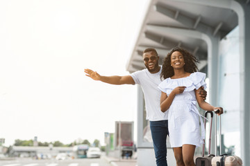 African american man and woman trying to catch taxi, arriving at airport
