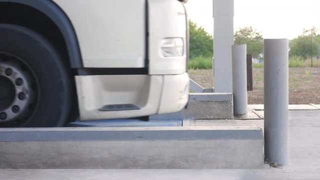 Side view of truck pulls onto the scales