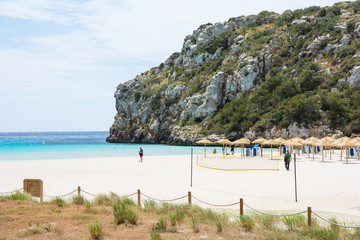People arriving to Cala en Porter beach, Menorca - obrazy, fototapety, plakaty