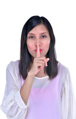 Naklejka premium Portrait of attractive teenage girl with finger on lips, isolated over white background concept of student show quiet, silence, secret gesture, young pretty brunette woman