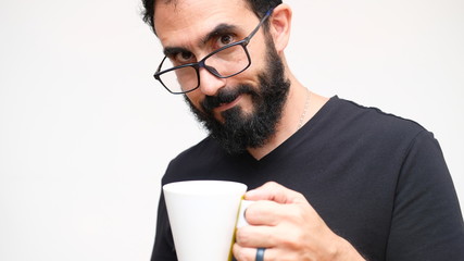 Middle age man in a white backround holding a cup of coffee 