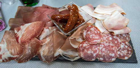 Sliced mixed Italian: Salami, raw ham, bacon and dry tomatoes.