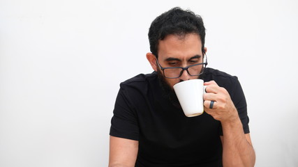Middle age man in a white backround holding a cup of coffee 