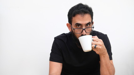 Middle age man in a white backround holding a cup of coffee 