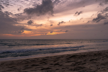 Fototapeta na wymiar Orange sunset sky with cloud tropical area at Phuket Thailand.