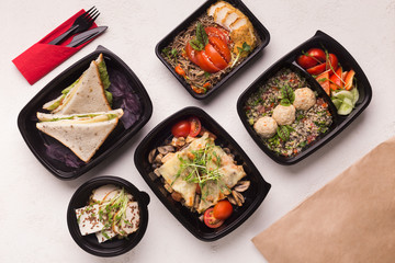 Healthy food in black boxes with daily ration