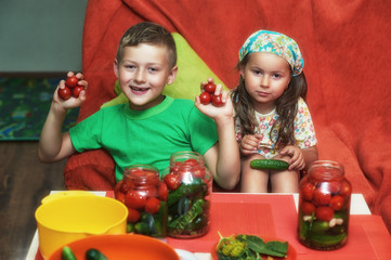 Children cook vegetables for the winter . Home canning . Help parents in the kitchen .