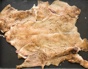 Raw skin taken from a duck. Goose skin, after plucking the feathers and removing the pinfeathers with an open flame. Goose skin texture.