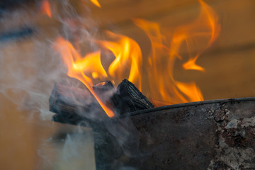Close-up on a fire during a fire or burning fire on the background of a wooden wall. Work for firefighters.
