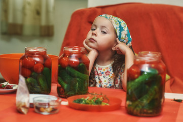 Children cook vegetables for the winter . Home canning . Help parents in the kitchen .