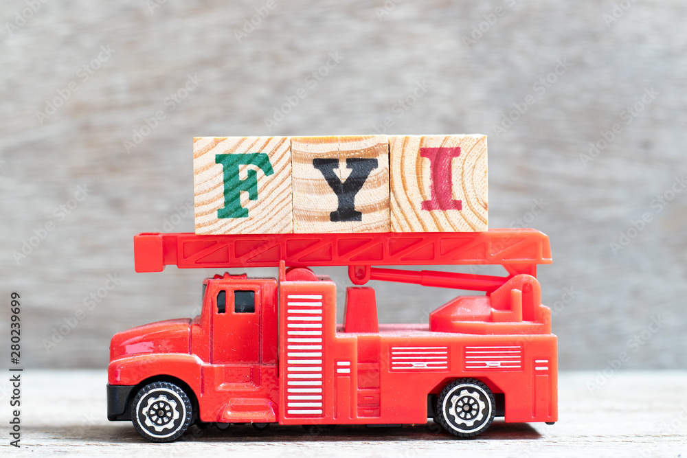 Canvas Prints Red fire truck hold letter block in word FYI (Abbreviation of For your information) on wood background