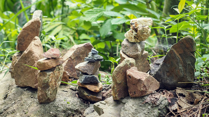 Beautiful Zen Concept Art of Stacked Stones Show Balancing and Harmony with Forest Background (Selective Focus and Blurred Background).