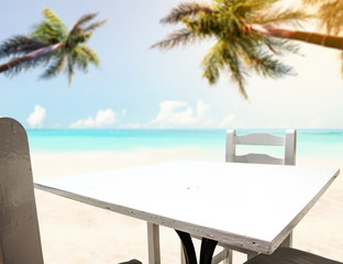 Table background on a beautiful ocean and sandy beach view in distance.