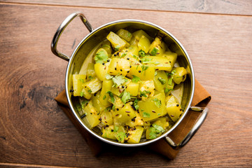 Lauki/doodhi ki sookhi Sabji also known as bottle gourd dry vegetable recipe. served in a bowl or karahi. selective focus