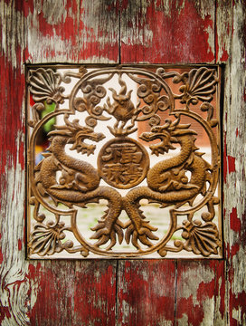 Detailed carving of a dragon in a wooden door, Vietnam, Southeast Asia
