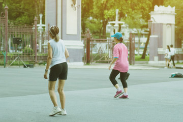 Group of elderly friend doing aerobic dance after work   together at Lumpini Park in Bangkok,...