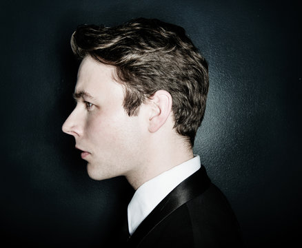 Profile of a young man in a suit