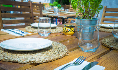 Sun terraces with empty glass glasses and table set to eat or have a snack in Marbella, Malaga, Spain